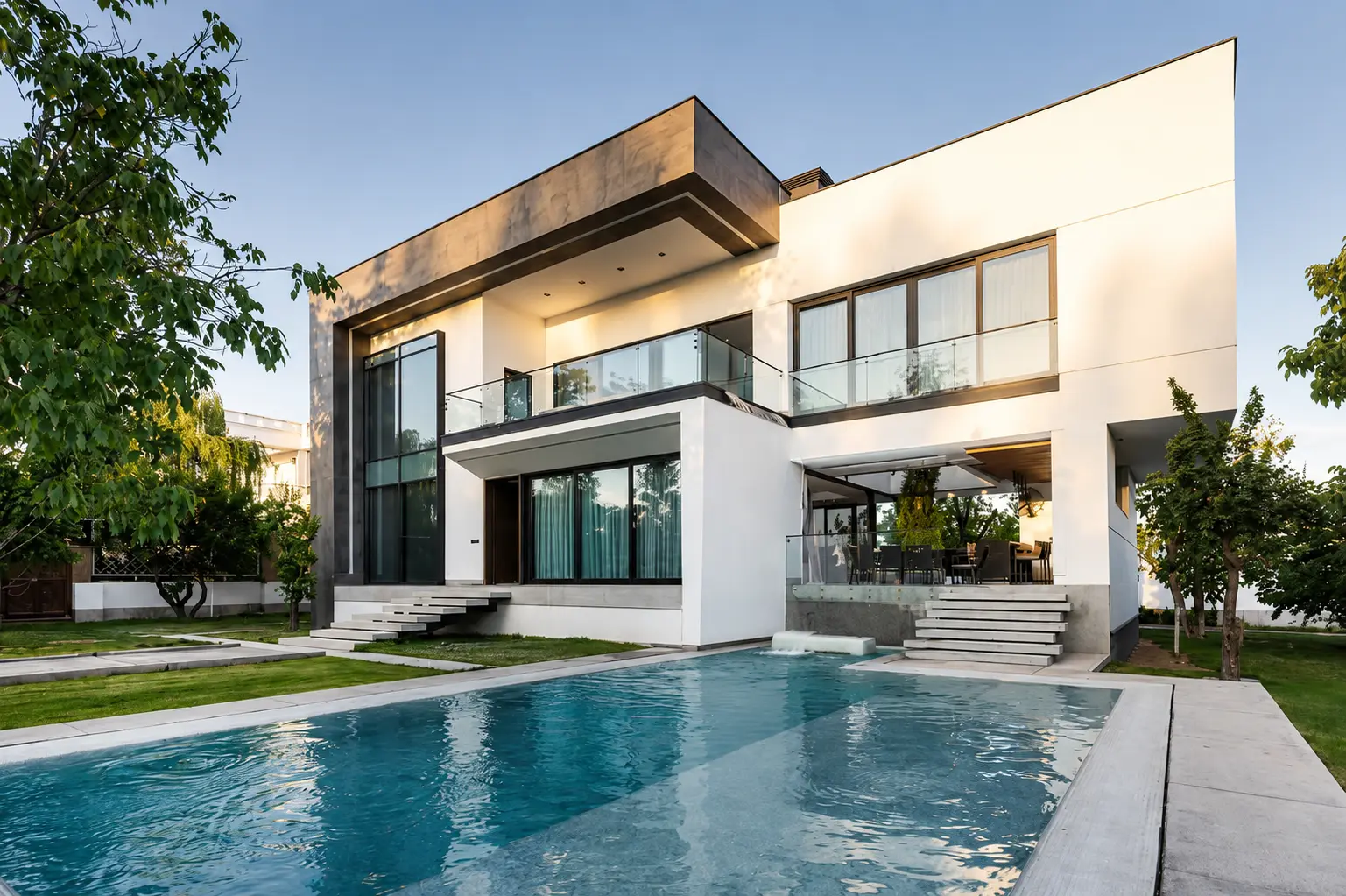 Contemporary FARHO villa with white and charcoal cantilevered volumes overlooking a long blue pool and landscaped garden.